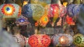 Colourful turkish lamps from glass mosaic glowing. Arabic multi colored authentic retro style lights. Many illuminated moroccan