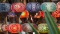 Colourful turkish lamps from glass mosaic glowing. Arabic multi colored authentic retro style lights. Many illuminated moroccan