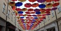 Colourful umbrellas over hanging a street