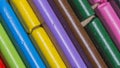 Colourful used crayons in a diagonal row