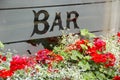 Colourful window box brims with flowers outside bar window