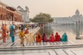 Amritsar, India - October 12, 2010: Women sitting on the edge of lake surrounding the Golden Temple Royalty Free Stock Photo