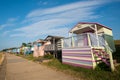 Colourful wooden beach huts facing the ocean at Whitstable coast, Kent district England