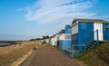 Colourful wooden beach huts facing the ocean at Whitstable coast, Kent district England