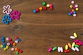 colourful wooden beads different shapes on wooden background, walnut wood background with wooden beads, banner copy space Royalty Free Stock Photo