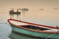 Colourful wooden boats in the morning mist take visitors around on the river Ganges in Varanasi, India Royalty Free Stock Photo