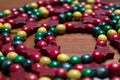 Colourful wooden Christmas beads arranged in a spiral on a wooden surface Royalty Free Stock Photo