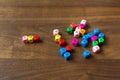 colourful wooden cube beads with letters on wooden background, wthout "E", missing letter in the word "love Royalty Free Stock Photo