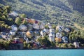 Colourful wooden houses for living on mountains slope near Norwegian fjord, the Odda town, Hordaland county, Norway