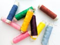 Colourful yarn on spool tube thread isolated image on white background.