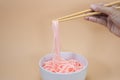 Colourful yarn in white bowl and chopsticks look like a noodles,food design concept