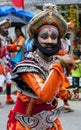 A colourfully dressed dancer performs through the streets during the Hikkaduwa Perahera