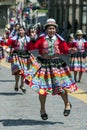 Colourfully dressed performers dance down a Cusco street during the May Day parade in Peru.