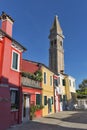 Colourfully painted houses and Leaning tower on Burano island, Italy. Royalty Free Stock Photo