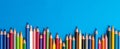 Colouring pencils isolated on blue background close up concept with copy space for text Royalty Free Stock Photo