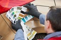 Colourist man selecting color of car with paint matching samples