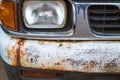 Colse up to decay and rust on the front bumper of an old white truck. Royalty Free Stock Photo