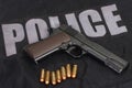 colt m1911 handgun with ammo on police uniform