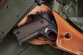 Colt pistol in holster and belt lie on military jacket Royalty Free Stock Photo