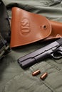 Colt pistol and holster lie on military jacket