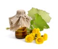 Coltsfoot flowers with pharmaceutical bottle.