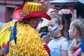 Columbian sport fan drawing russian flag on the cheek of the young caucasian girl sport fan Royalty Free Stock Photo