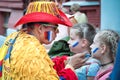 Columbian sport fan drawing russian flag on the cheek of the young caucasian girl sport fan Royalty Free Stock Photo