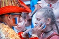 Columbian sport fan drawing russian flag on the cheek of the young caucasian girl sport fan at the street in the center of Moscow Royalty Free Stock Photo