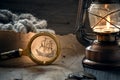 The concept of adventure and treasure hunting. an old map of pirate treasures, an old lamp, a ship`s rope and coins Royalty Free Stock Photo