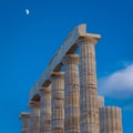 Column of the ancient greek Temple of Poseidon with the moon in Cape Sounion, Greece Royalty Free Stock Photo