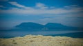 Column basalts formation of Stolbchaty cape at Kunashir, kuril islands, Russia, and Hokkaido island on background, Japan Royalty Free Stock Photo