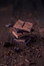 Column of dark or bitter or milk chocolate on a wood background Royalty Free Stock Photo
