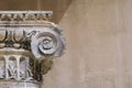 Roman capital of the ionic order on the background of the wall