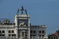 Column with lion of St Mark, symbol of imperial Venice, Zodiac clock Tower and Mother of God in San Marco`s square on the buildin Royalty Free Stock Photo