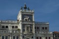 Column with lion of St Mark, symbol of imperial Venice, Zodiac clock Tower and Mother of God in San Marco`s square Royalty Free Stock Photo