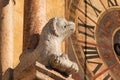 Column pier with lion sculpture and clock face of romanesque Duomo di Verona Royalty Free Stock Photo