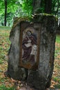 Column with religious icon and sentence `Ora Pro Nobis` on top, placed on Island Of Art in center of Orava River Dam Royalty Free Stock Photo