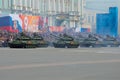 A column of the Russian tanks against the background of festive stands. A dress rehearsal of a parade in honor of the Victory Day