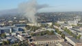 Column of smoke from a fire in the city: aerial drone view