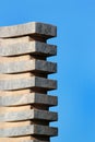 Column or stack of stone blocks against blue sky Royalty Free Stock Photo