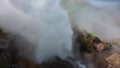 A column of thick steam rises from the cauldron of an erupting geyser Royalty Free Stock Photo