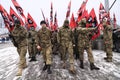 Column of Ukrainian far-rightists marching on the street with flags in hands Royalty Free Stock Photo