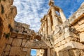 Columns of ancient Roman temple of Bacchus with surrounding ruins and blue sky in the background, Beqaa Valley, Baalbeck, Lebanon Royalty Free Stock Photo