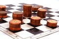 Columns of coins on the chessboard Royalty Free Stock Photo