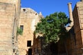 Columns on the hellenistic stoa of the Acropolis of Lindos, Rhodes, Greece, Blue sky, olive tree and beatiful sea view in the back Royalty Free Stock Photo