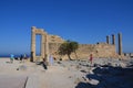 Columns on the hellenistic stoa of the Acropolis of Lindos, Rhodes, Greece, Blue sky, olive tree and beatiful sea view in the back