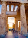 Columns of Propylaea entrance gateway of Acropolis, Athens, Greece overlooking the sunset and the city