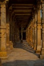 Columns with stone carving in courtyard of Quwwat-Ul-Islam mosque, Qutub Minar complex, Delhi, India Royalty Free Stock Photo