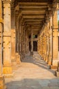 Columns with stone carving in courtyard of Quwwat-Ul-Islam mosque, Qutub Minar complex, Delhi, India Royalty Free Stock Photo