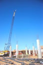 A Lattice-Boom Crane sits among Concrete Columns Royalty Free Stock Photo